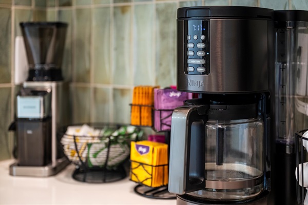 The coffee bar includes a grinder, drip coffee, French press, Keurig machine, and kettle for hot tea.
