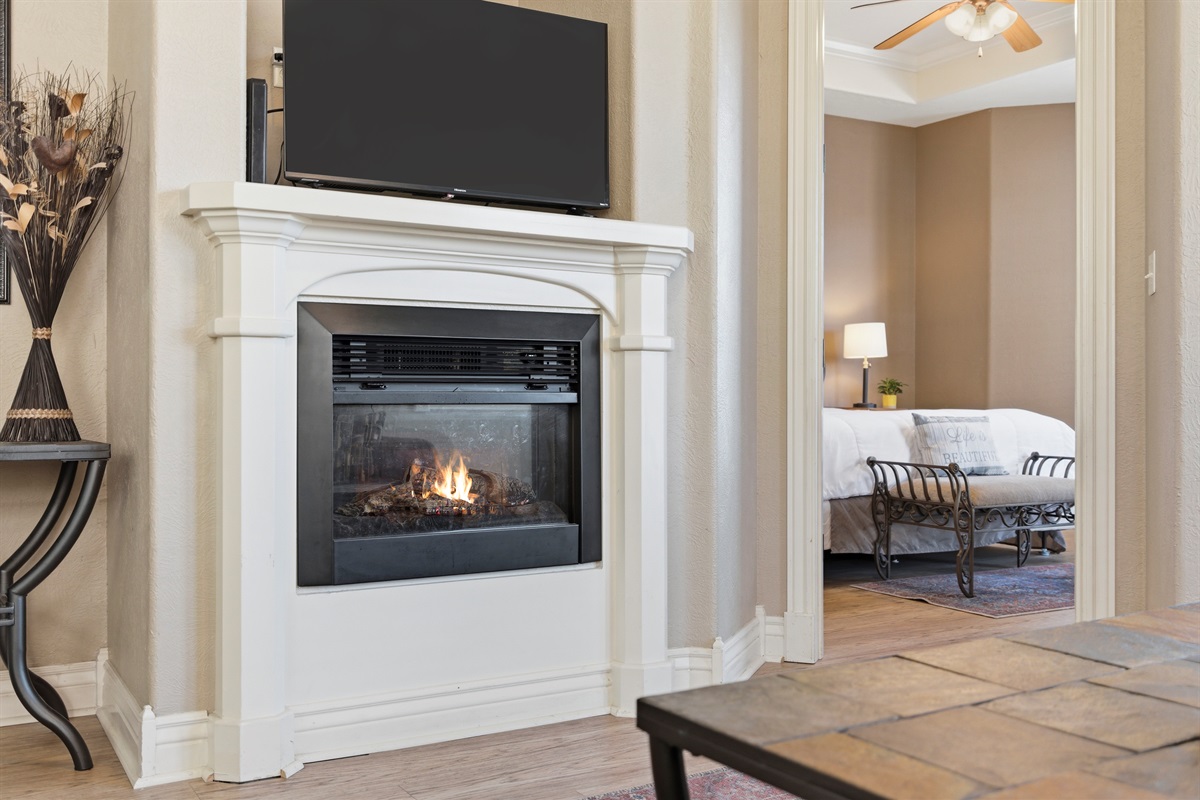 Cozy living room with fireplace and dining space perfect for relaxing together.