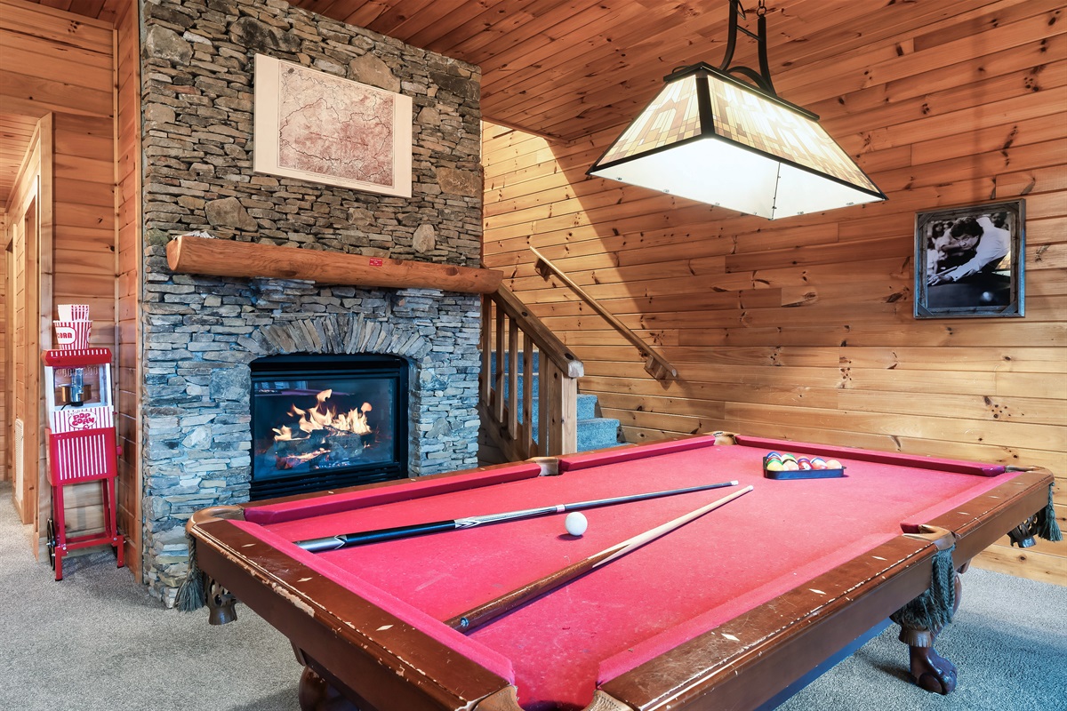 Pool table, theater and fireplace on the lower level