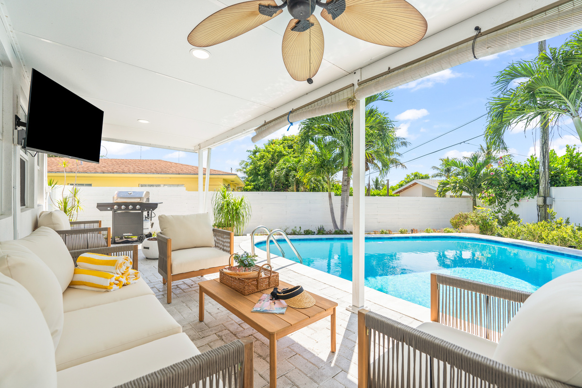 Relax by the pool from the comfort of the covered patio