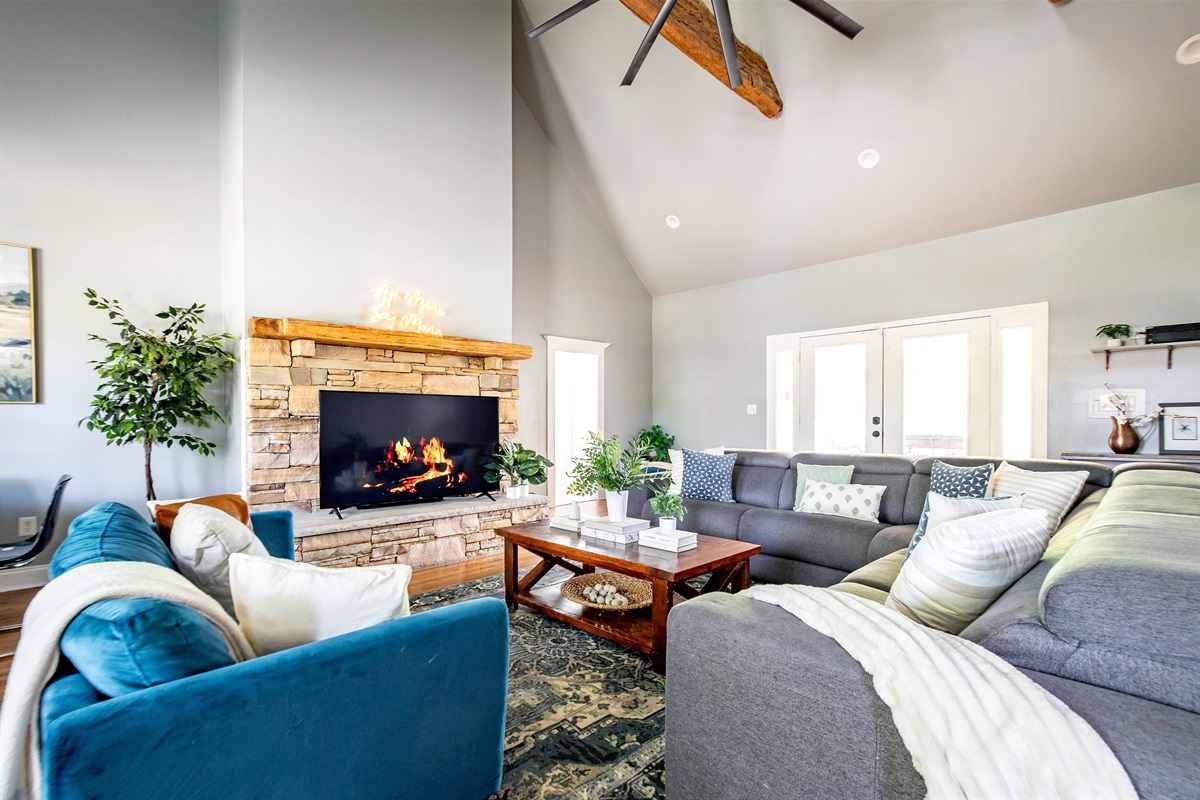Spacious living room with vaulted ceilings, game table, TV