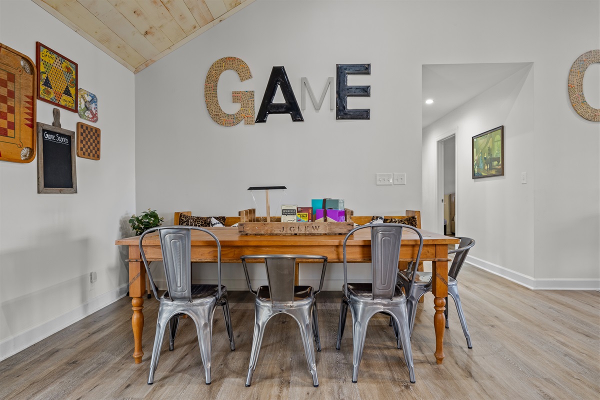Back living room features game table + seating area.