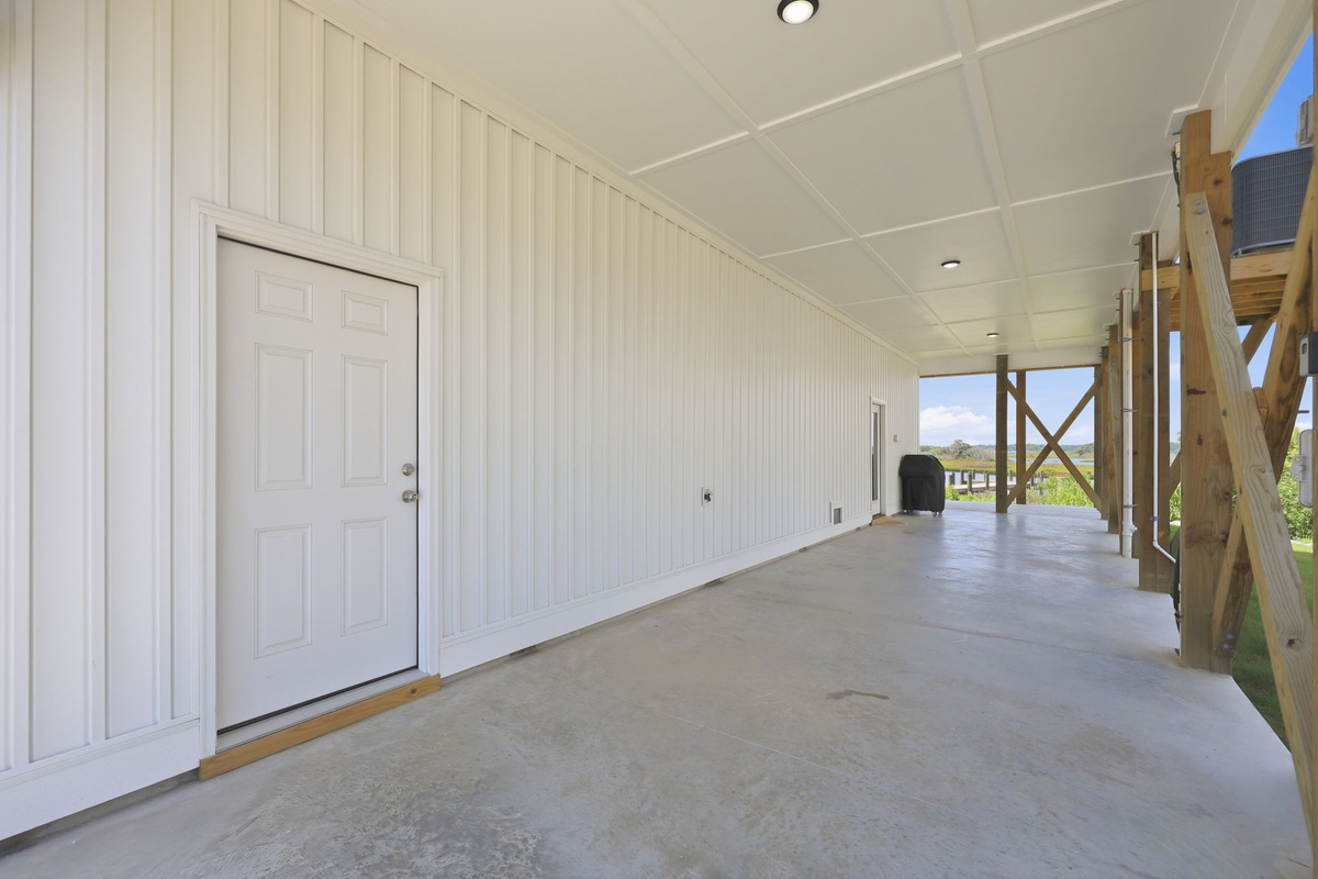 Covered parking and a spacious ground-level area provide plenty of room for vehicles, gear storage, and easy access to the home