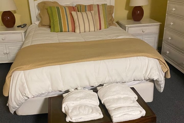 This bedroom is part of a small in-law suite on the lower level. It includes a sitting area, full kitchen, and private full bathroom.