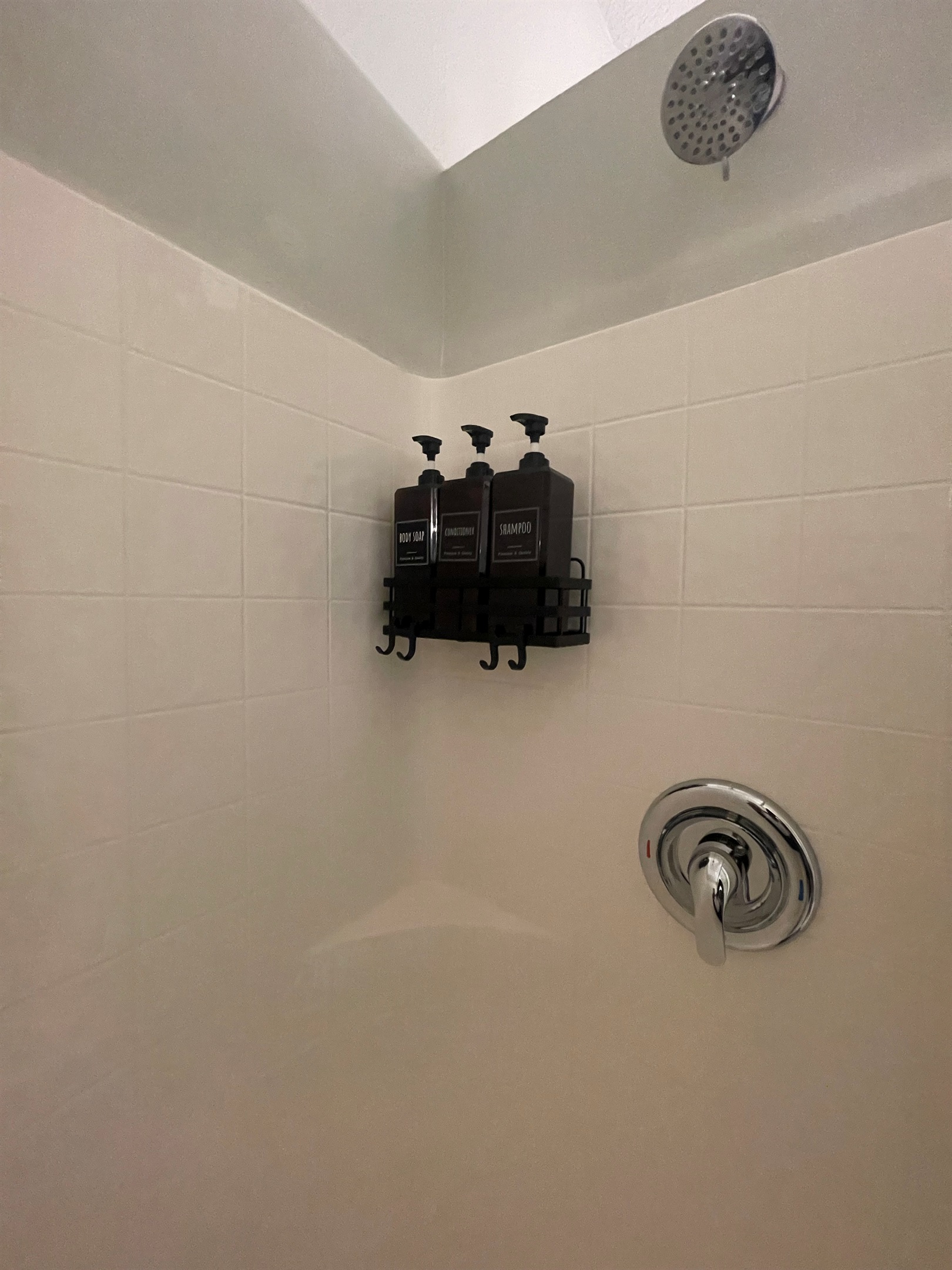 Clean and spacious shower with modern fixtures, designed for a refreshing and relaxing experience.