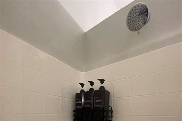 Clean and spacious shower with modern fixtures, designed for a refreshing and relaxing experience.