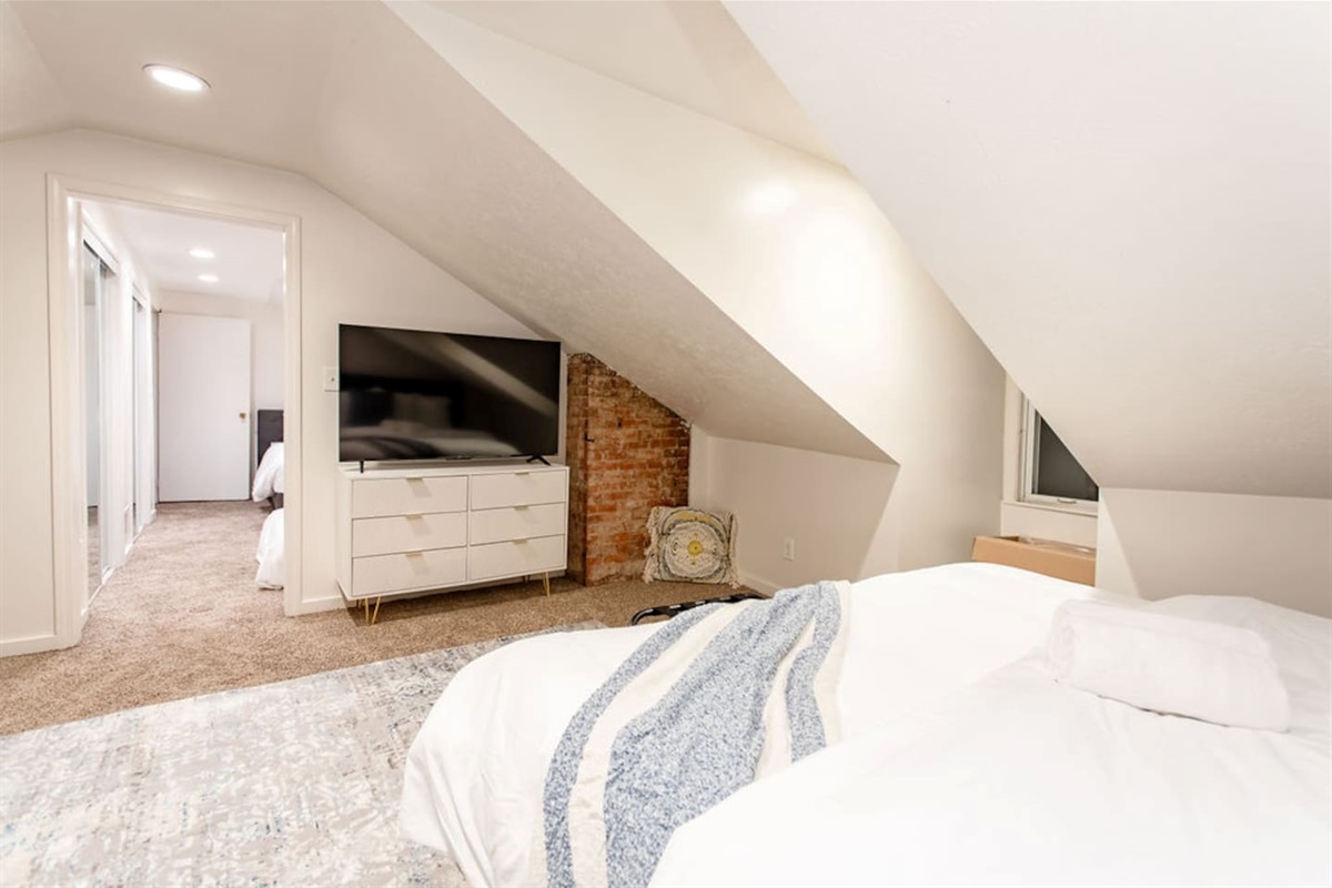 Spacious bedroom featuring two king beds, offering ample comfort and plenty of space for families or groups looking to relax together.