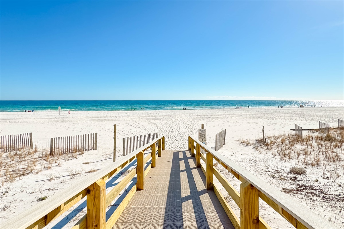Seamless access to the pristine sands and emerald waters. The Four Winds boardwalk, your pathway to paradise.