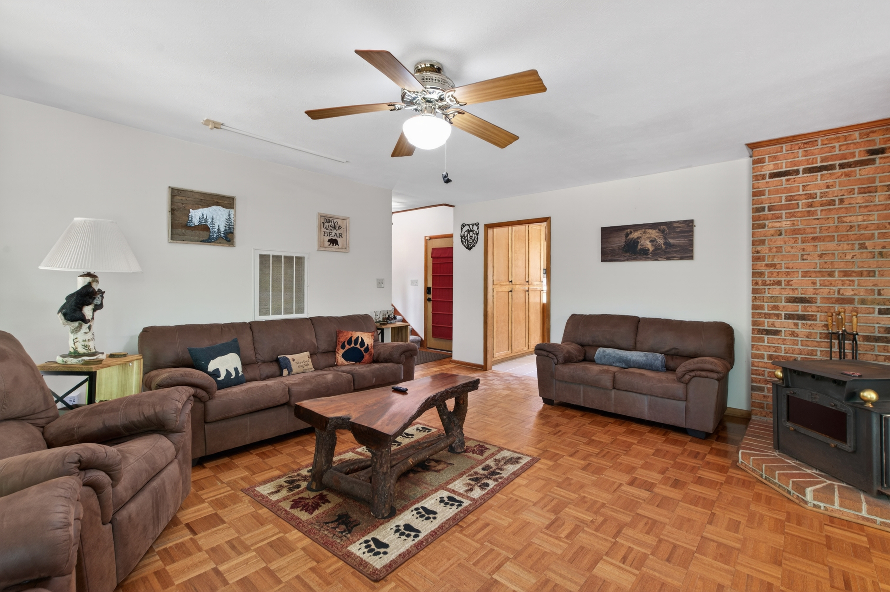 Living Room: Rustic charm awaits with plush seating, a warm fireplace, and delightful decor!