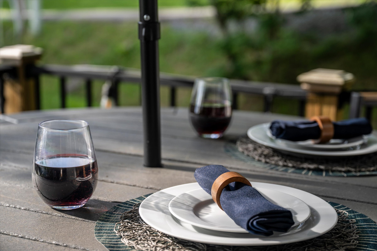 Deck with Blackstone Grill, cafe lights, bistro table and sitting chairs