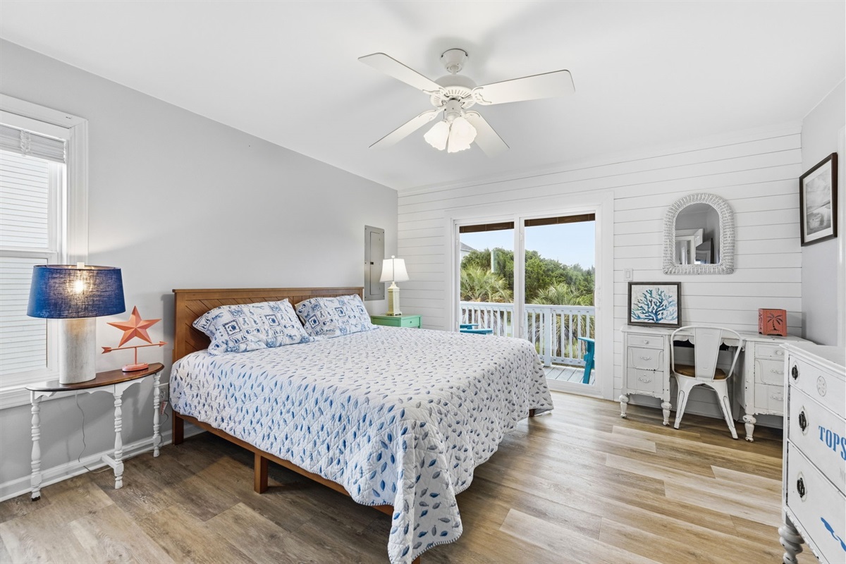 King suite featuring a ceiling fan, ample storage, work desk, and private deck access for added comfort and convenience.