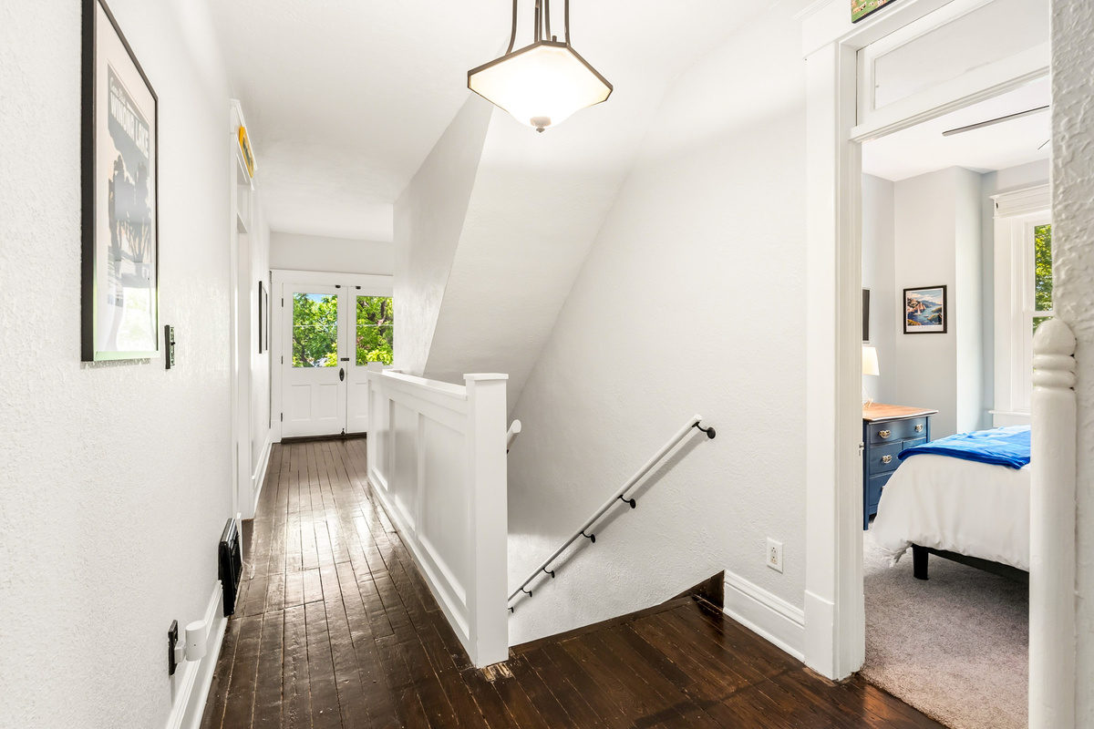 Moving upstairs! The upper level layout combines 1910 architectural charm with modern comfort, offering a spacious, natural separation between the bustling main floor and the peaceful upstairs bedrooms.