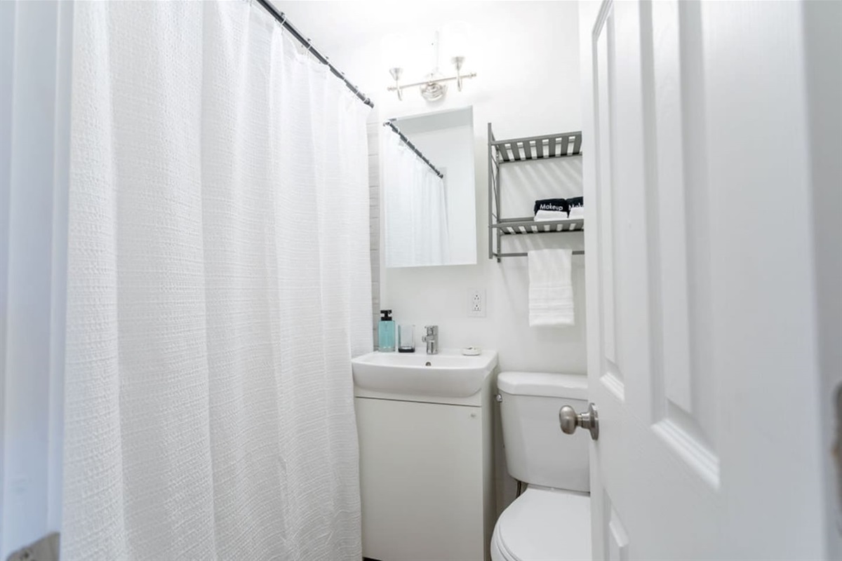 Modern full bathroom with sleek fixtures and plenty of space for a refreshing and relaxing experience.