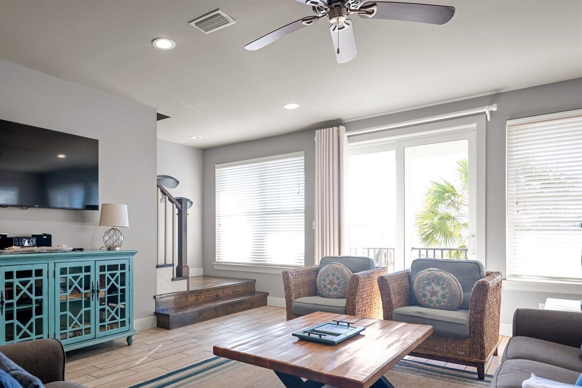 Living room area with plenty of seating and wall mounted Smart TV. Guests must log in to their own streaming services