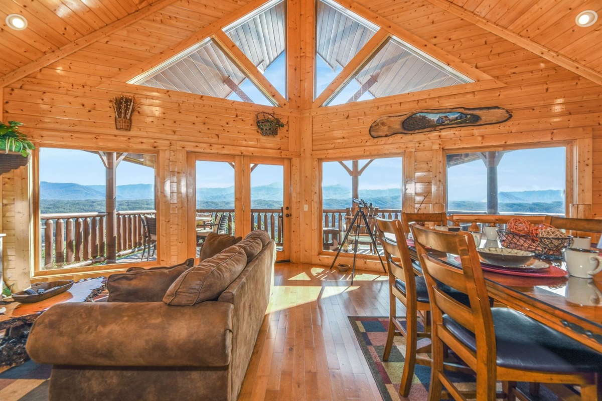 - Expansive glass windows open up to breathtaking Smoky Mountain scenery   - Cozy seating and a dining area perfectly positioned to soak in the views   - Experience mountain living with open-air comfort and natural cabin charm