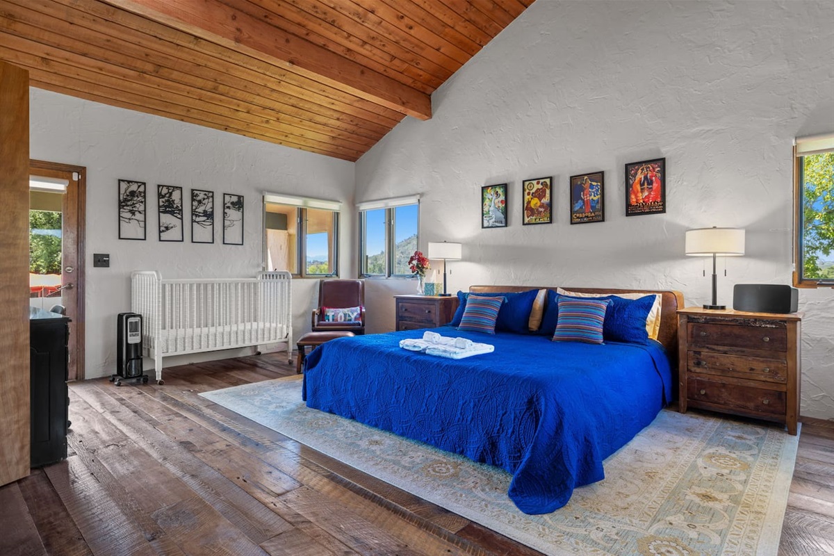 Master bedroom has crib and office desk