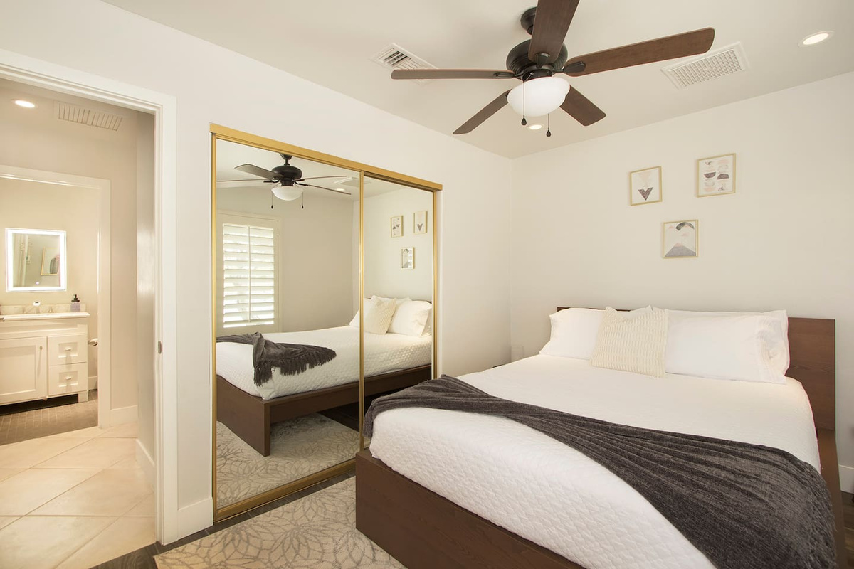 3rd bedroom with queen sized bed and full body length mirror