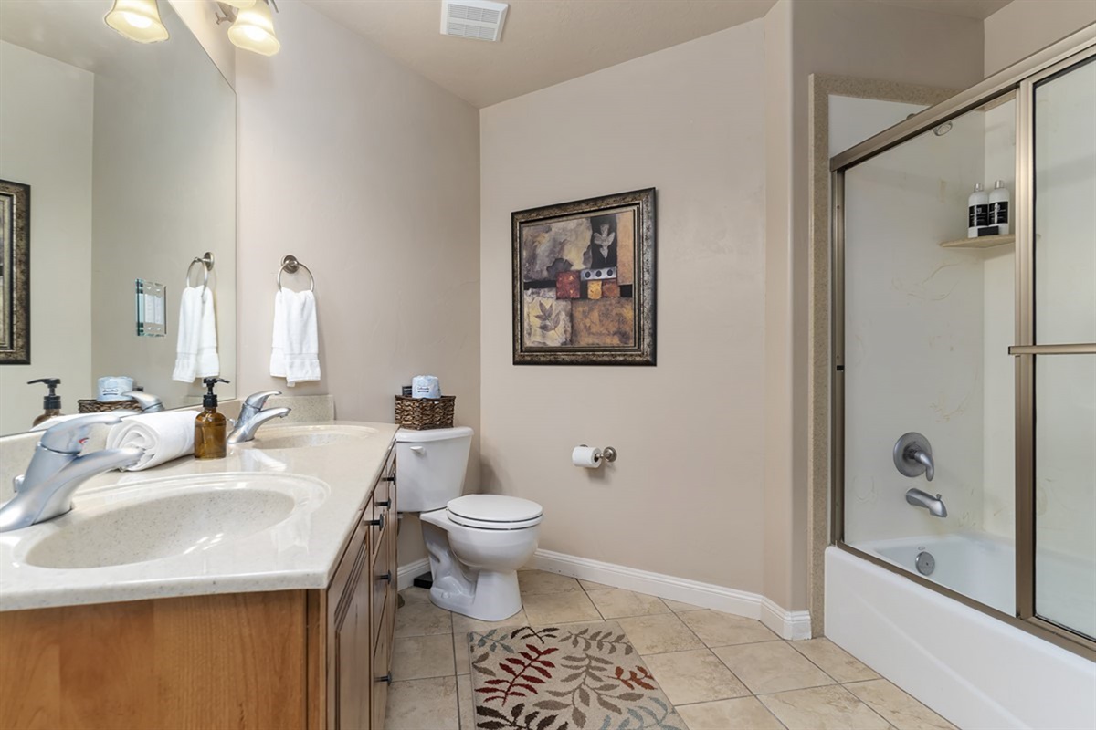 Clean and spacious full bathroom with vanity and walk-in shower for added convenience.