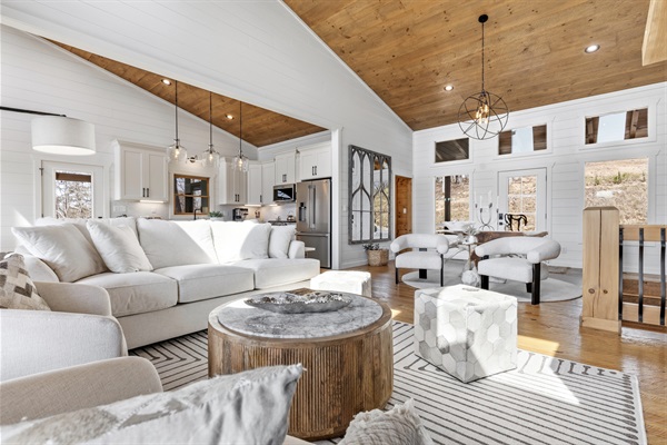 Bright and airy with vaulted wood ceilings and hardwood floors. Sink into the oversized couch and relax in this open-concept space. Neutral tones and cozy textures create the perfect soothing retreat.