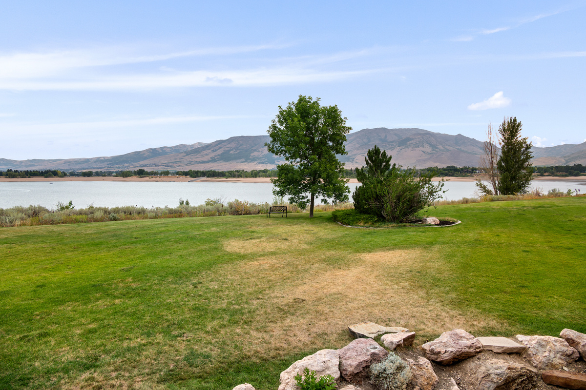 Expansive lawn, Pineview Reservoir, and mountain views create a picture-perfect setting for your Huntsville getaway.