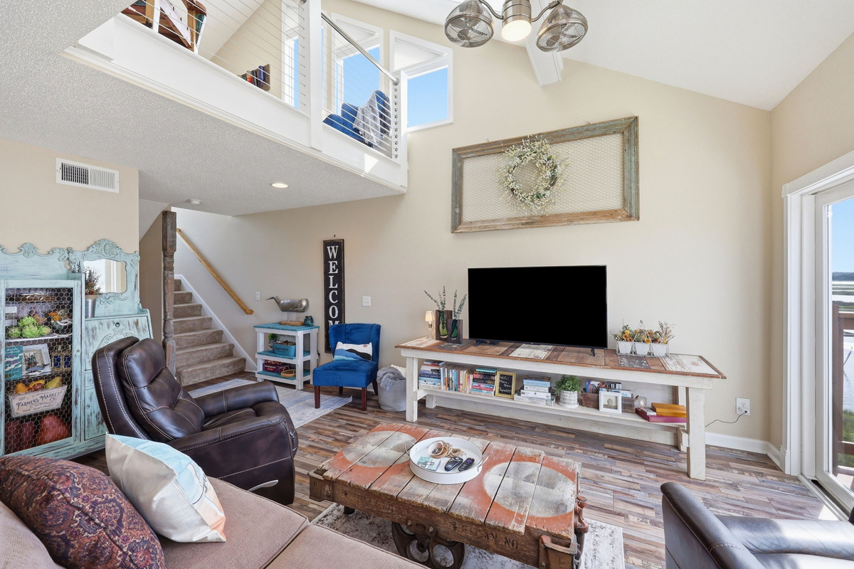 Relax with a good book or gather for movie nights in this comfortable coastal retreat. Large windows bring the beauty of the coast right into the living space.