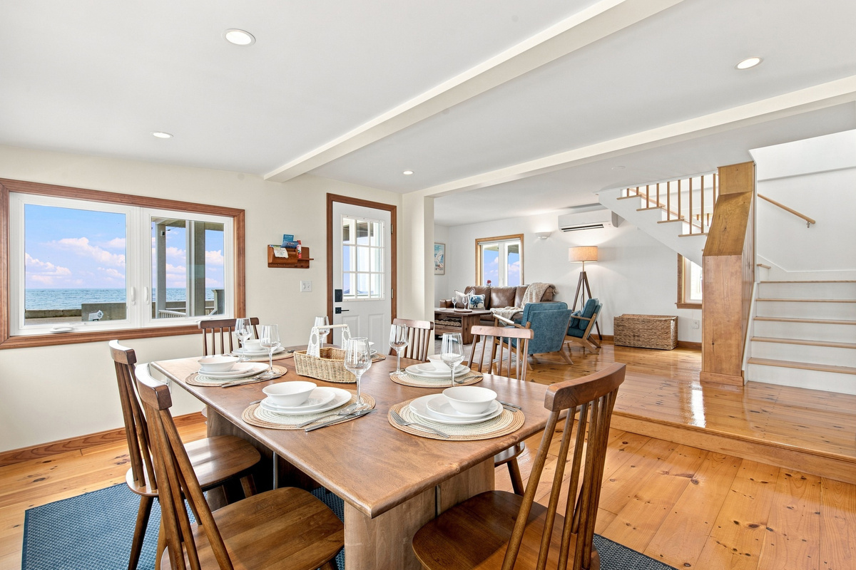 Open-concept dining space connecting the kitchen, living room, and outdoor deck.