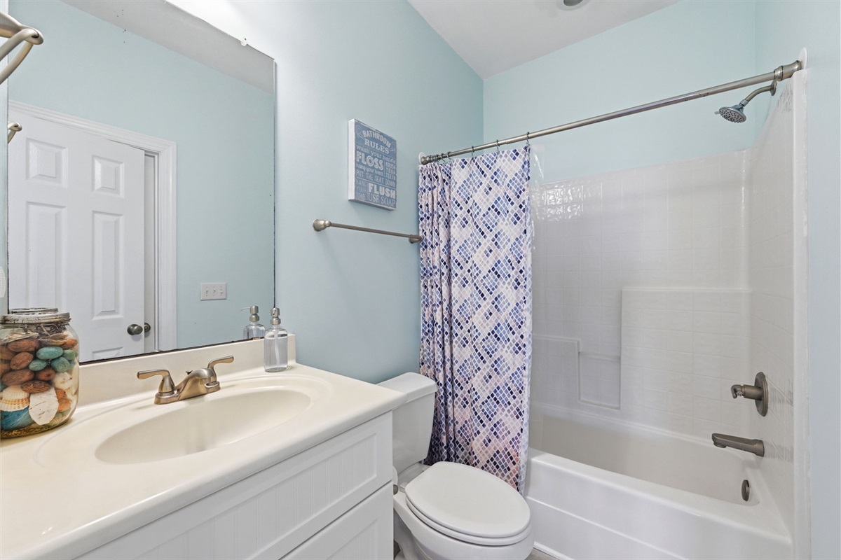 Clean and bright bathroom with tub and shower combo
