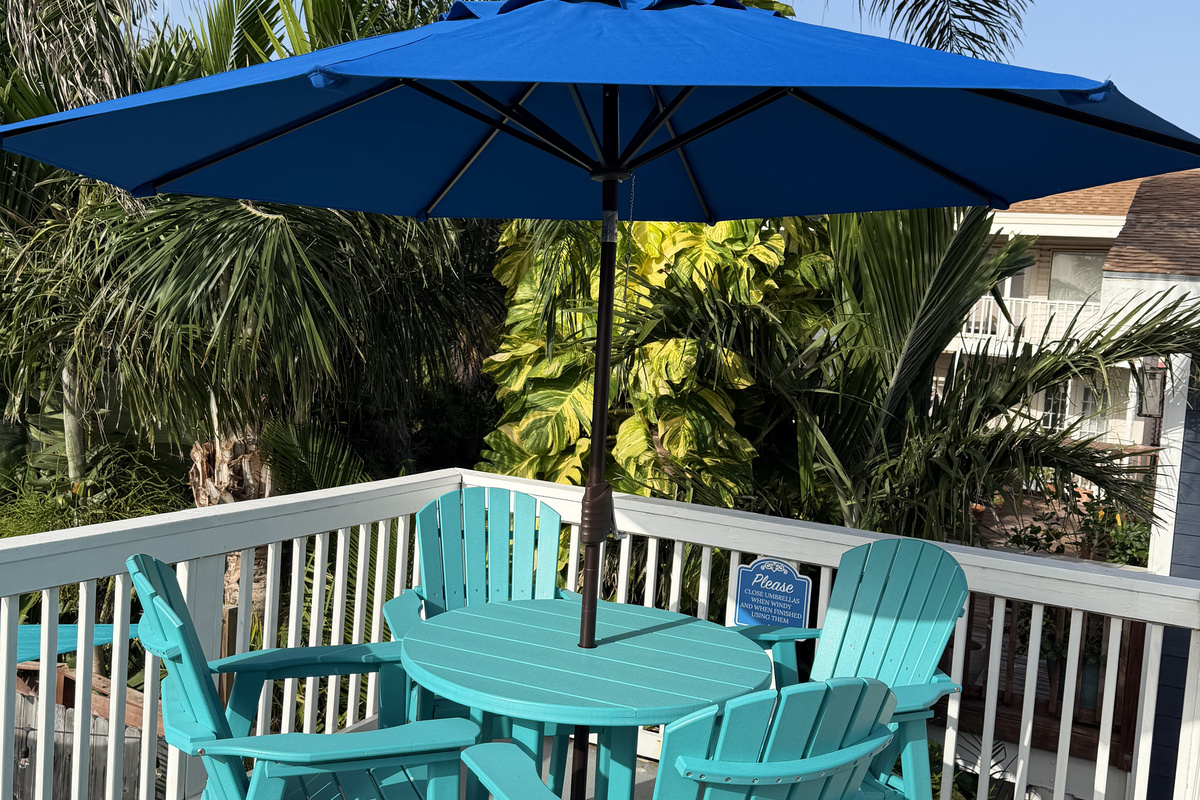 Upper balcony is the perfect spot to enjoy the South Padre Island sunshine and tropical surroundings. Umbrella provides a welcome shade on summer days.
