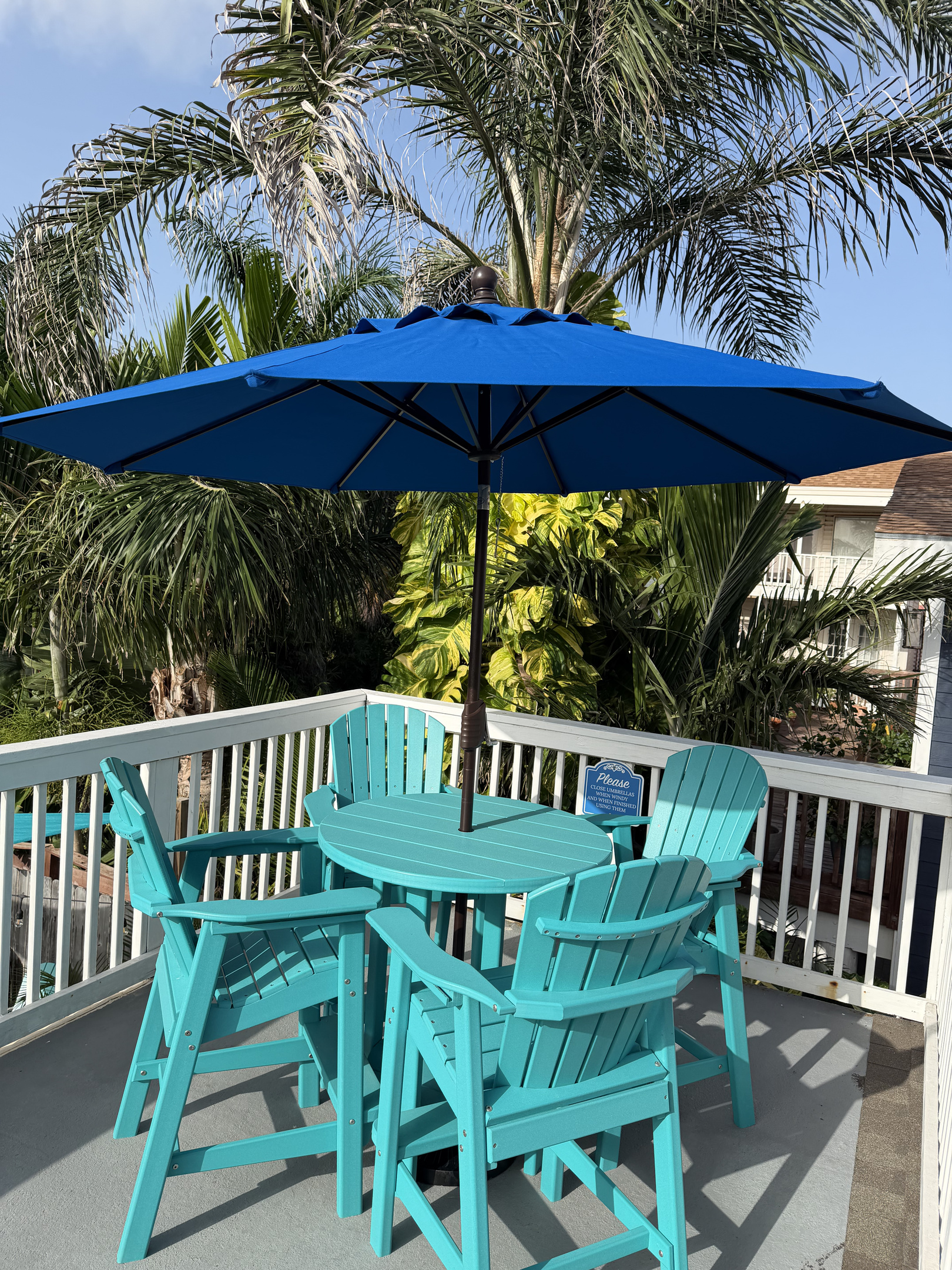 Upper balcony is the perfect spot to enjoy the South Padre Island sunshine and tropical surroundings. Umbrella provides a welcome shade on summer days.