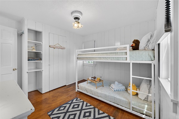 Cozy secondary sleeping space featuring twin bunk beds and efficient layout.