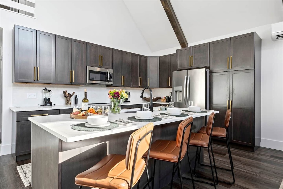 Details matter.  The gold hardware and the unique faucet add a touch of elegance to this modern kitchen.
