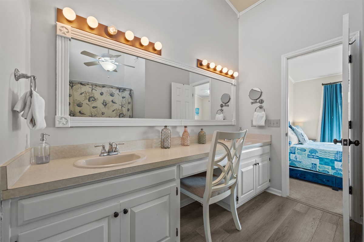 Bright master bathroom with a large mirror and plenty of counter space for your stay