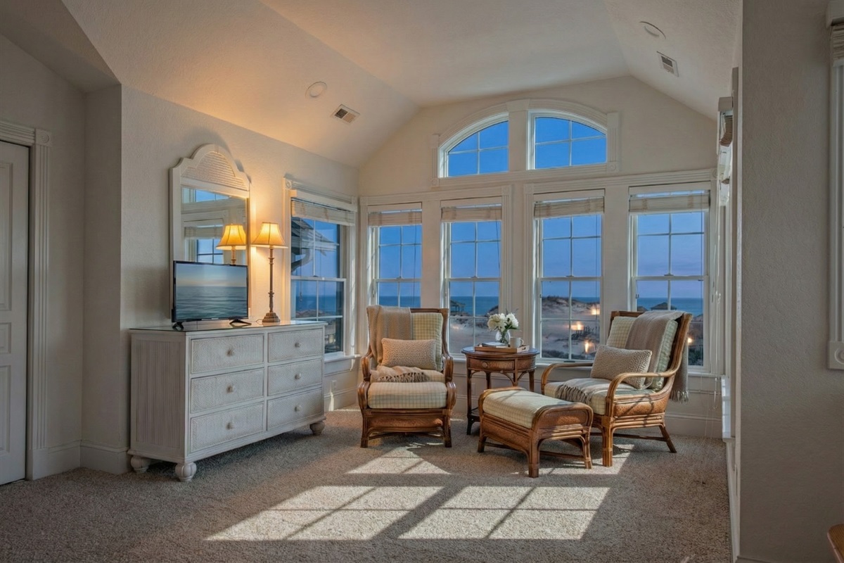 Escape to The Hemingway's master bedroom for a tranquil getaway. This serene, private retreat is complete with two arm chairs, making it the perfect spot for relaxation, rest, and rejuvenation