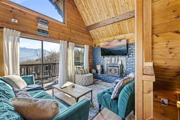 The main level family room features a large sofa, two chairs and an ottoman perfect for relaxing or kicking back on