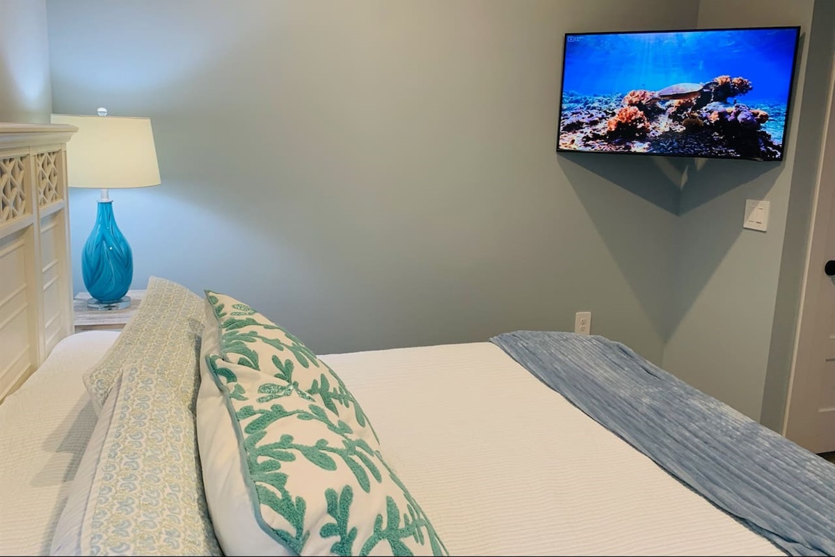 King bedroom with 43 inch Smart TV on adjustable mount.  