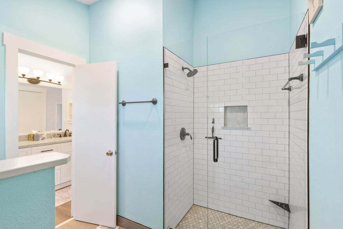 Your freshly tiled master shower is clean, modern, and just the right size &mdash; updated finishes make this feel anything but rental.