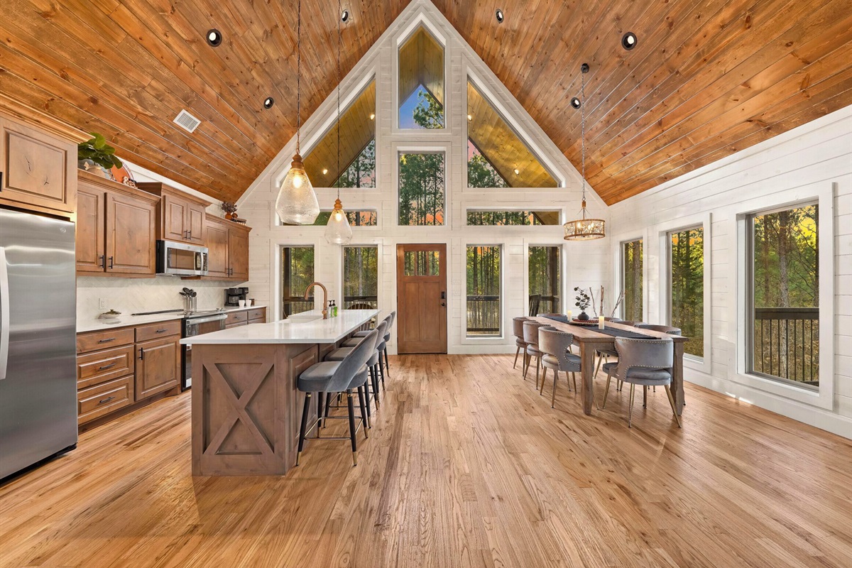 Bright kitchen and dining area with vaulted ceilings and natural light.