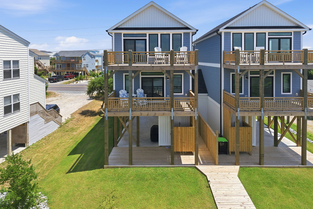 Aerial view showcasing the spacious dual-home property with expansive decks overlooking the peaceful marsh