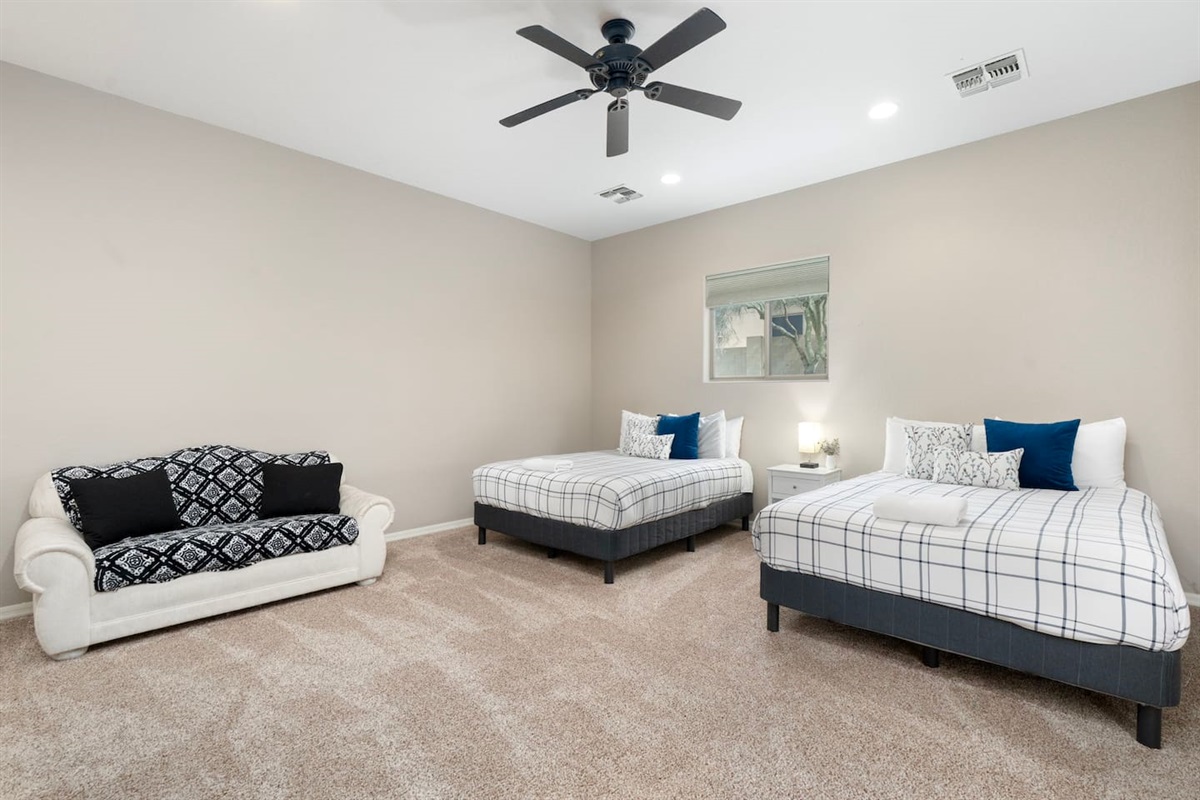 Bright and comfortable casita retreat featuring dual queen beds, cozy seating, and plenty of room to unwind after a long day.