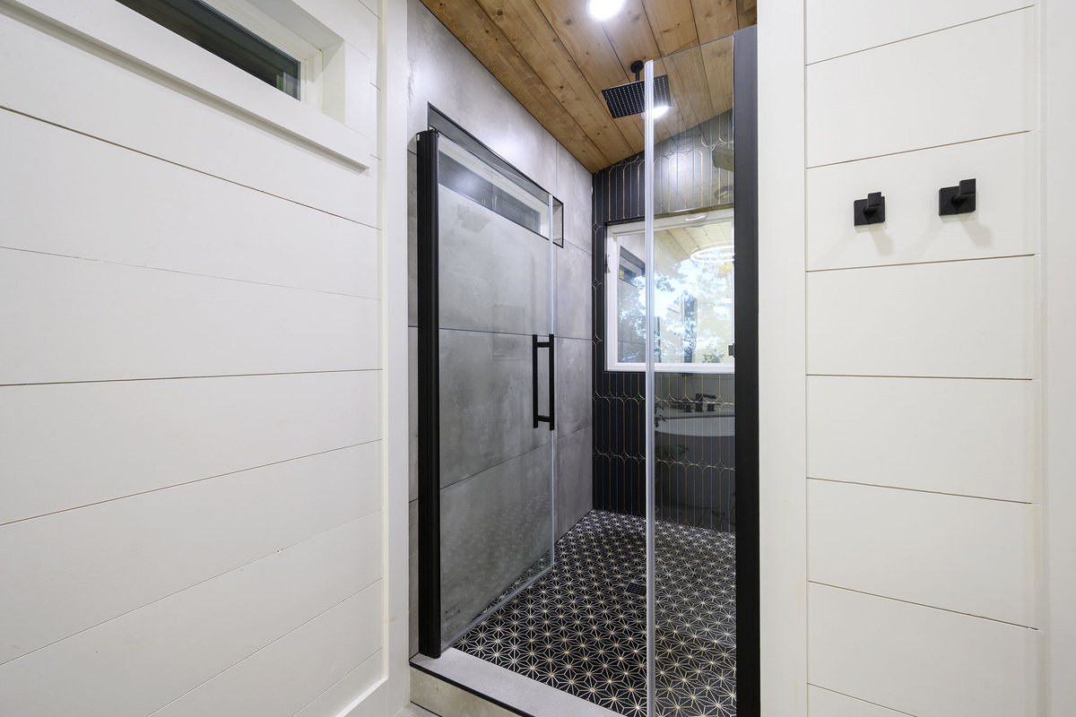 Luxury bathroom featuring a walk-in rain shower and inviting soaking tub.