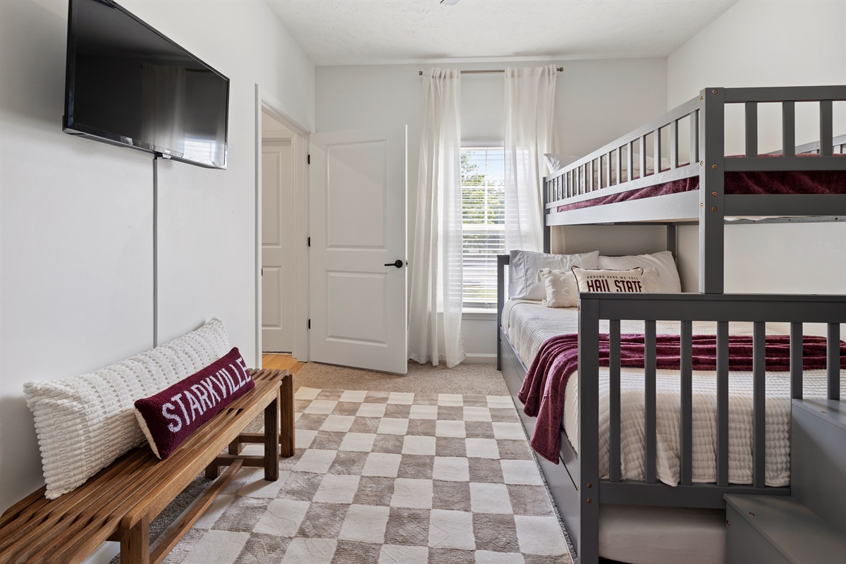 Kid-friendly bunk room with TV and cozy bean bag seating.