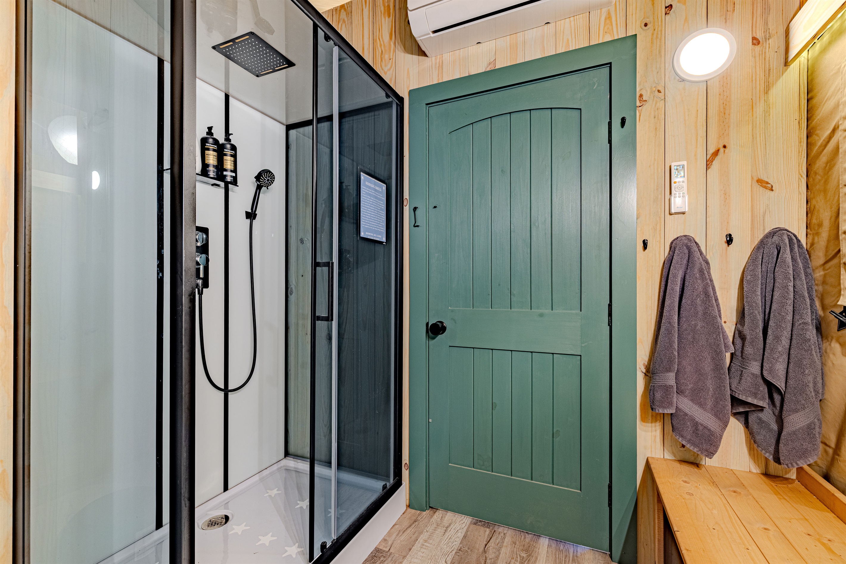 Your private, full-service bathroom. This fully enclosed shower features a rain head and hand-held nozzle, ensuring a refreshing and modern experience that leaves the "camping" part behind.