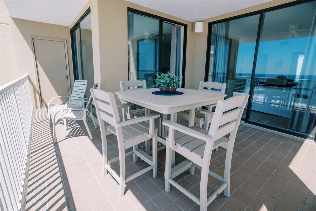 Three incredibly large floor-to-ceiling sliders overlooking the balcony and beachfront view.