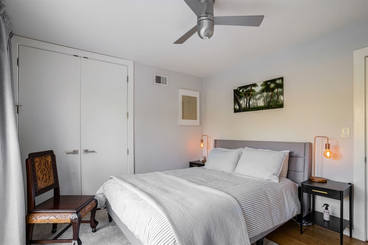 Bedroom 1 with queen bed and french doors to backyard and pool.