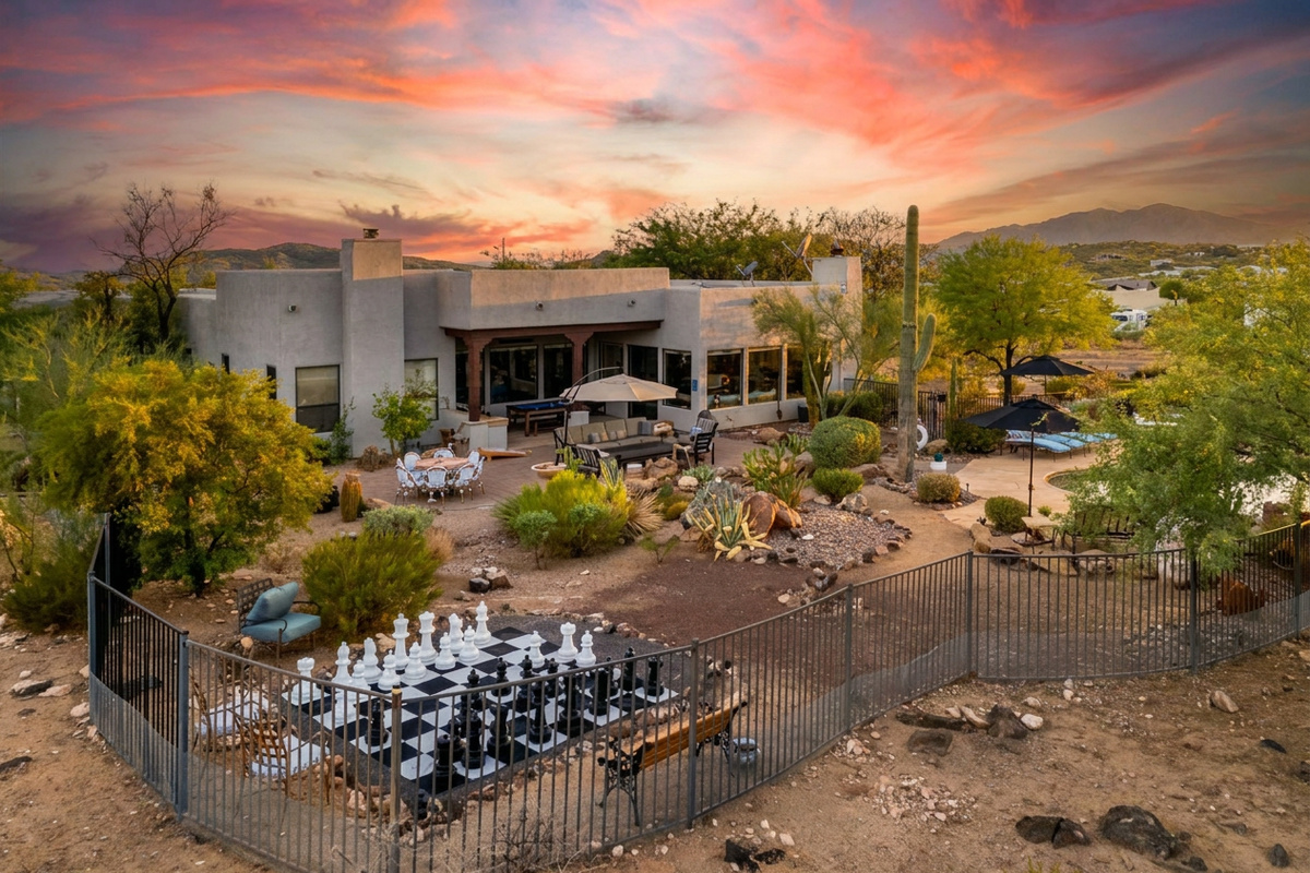 Huge fenced in patio area featuring giant chess, multiple lounge areas, billiards, ping pong, pool and hot tub. Fully fenced for easy enjoyment.
