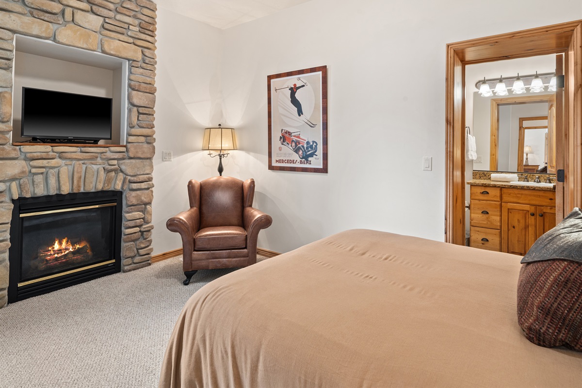 Primary bedroom with fireplace and relaxing sitting area