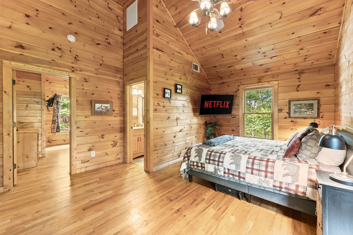 Private upstairs bedroom featuring a cozy full-size bed and peaceful cabin comfort for a restful stay.