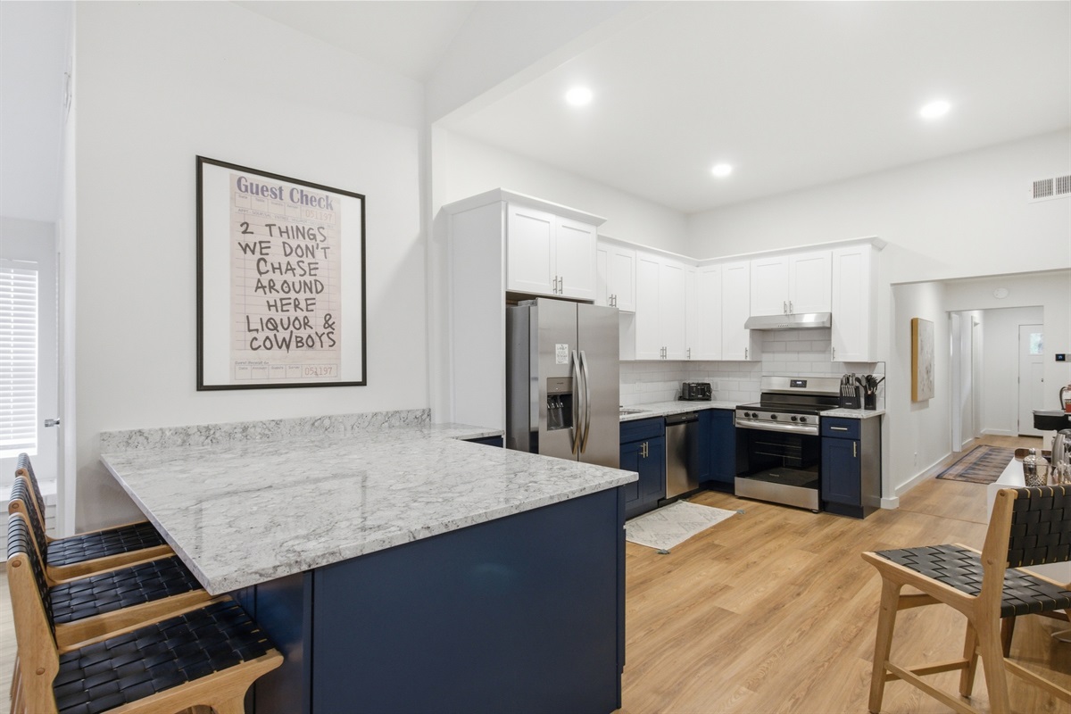 Full kitchen view with Frigidaire appliance suite. Dishwasher, Electric Stove, Oven, Freezer, and Refrigerator included. Fully stocked Arlington group rental.