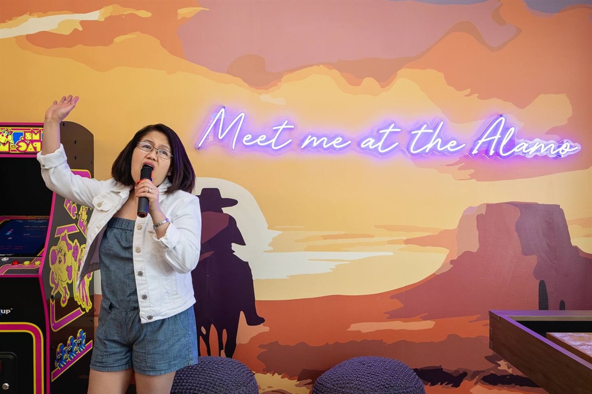Get ready to turn up the volume and sing your heart out! Gather your friends for a fun karaoke session in this vibrant space, belting out your favorite hits under the "Meet me at the Alamo" sign. Perfect for a memorable night of laughter and music!