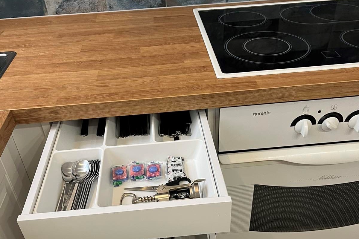 Utensils are in the cabinet next to the oven :)